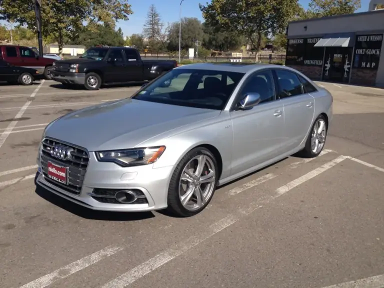 Silver Audi S6 with tinted windows in a parking lot