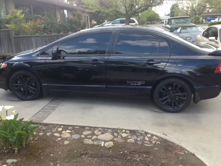 Black Honda Civic with tinted windows, side view