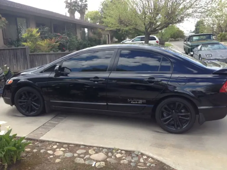 Black Honda Civic sedan with dark tint on every side window