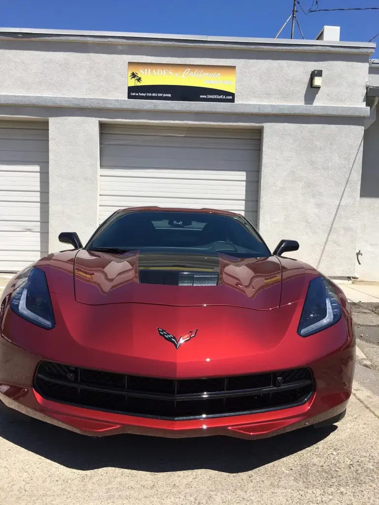 Red Corvette Stingray, front view, outside the shop