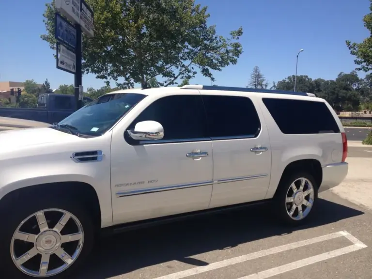 White Cadillac Escalade with dark tinted windows