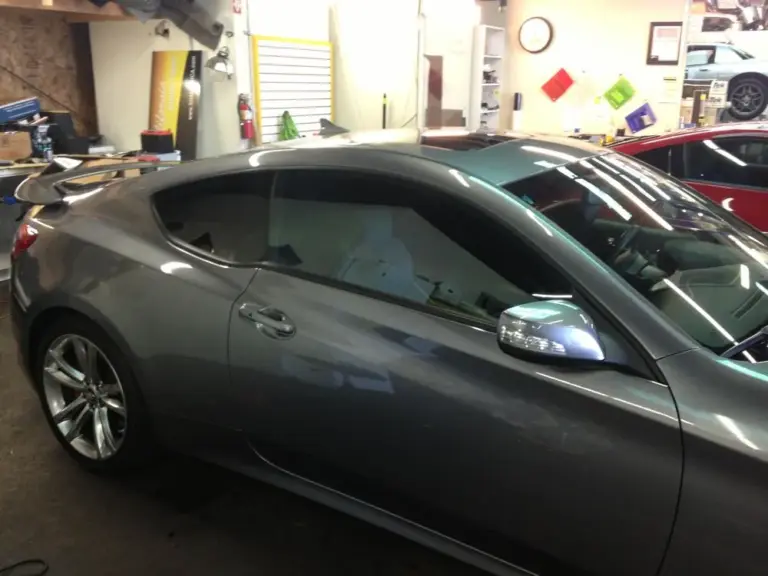 Gray Hyundai Genesis coupe with tinted windows in the shop