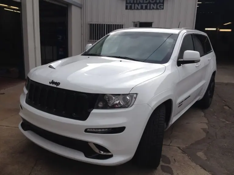 White Jeep Grand Cherokee SRT8 with tinted windows in the shop