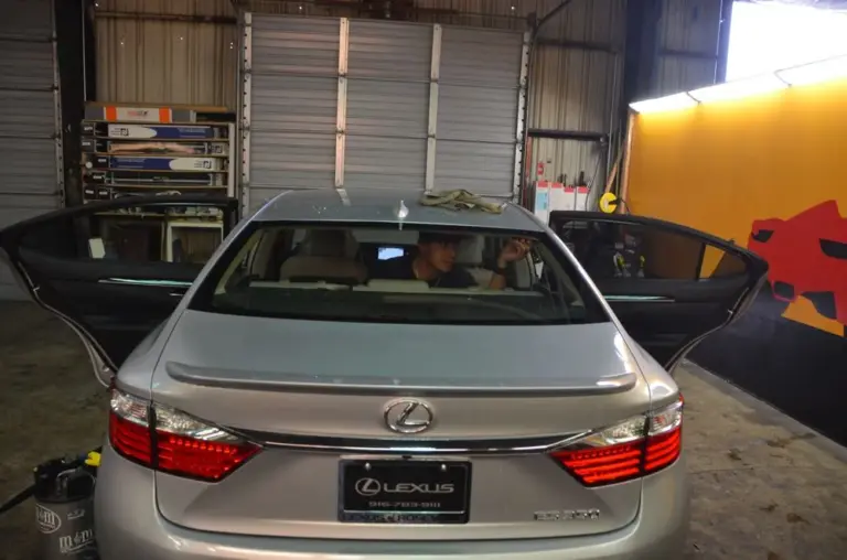 Silver Lexus ES in the shop during a tint install, doors open