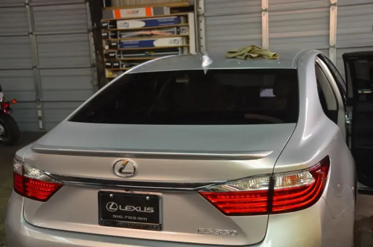 Silver Lexus ES with a freshly tinted rear window in the shop