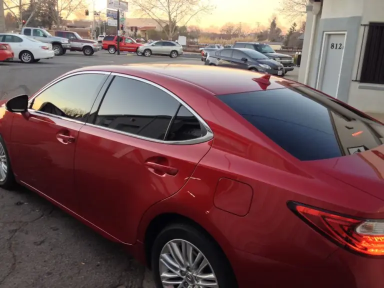 Red Lexus ES with tinted windows at sunset