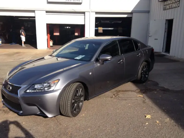 Gray Lexus GS F Sport with tinted windows outside the shop