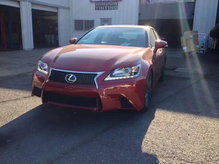 Red Lexus GS F Sport outside the shop