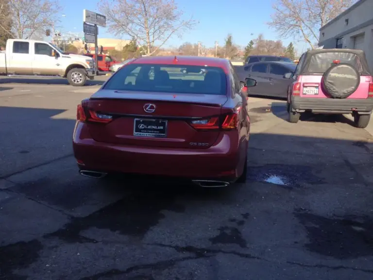 Red Lexus GS from behind with a tinted rear window