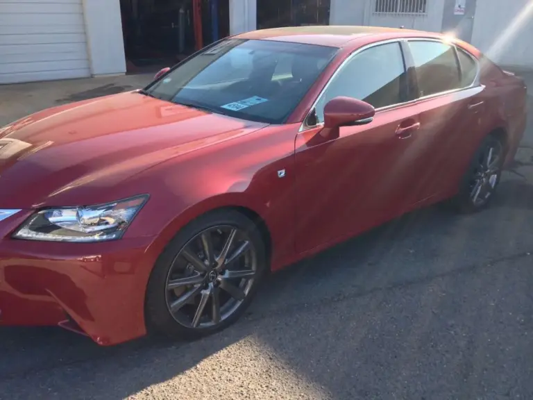 Red Lexus GS with tinted windows in the sun