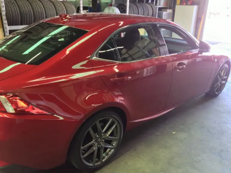 Red Lexus IS with tinted windows in the shop