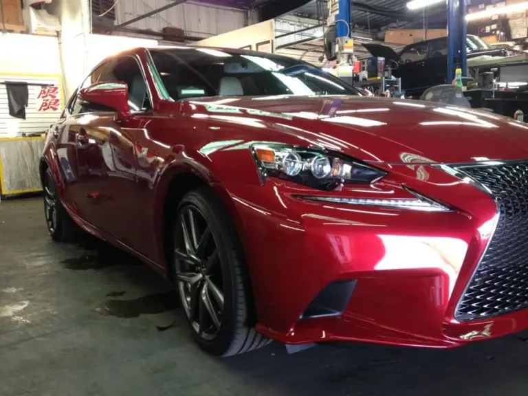 Red Lexus IS F Sport with tinted windows in the shop