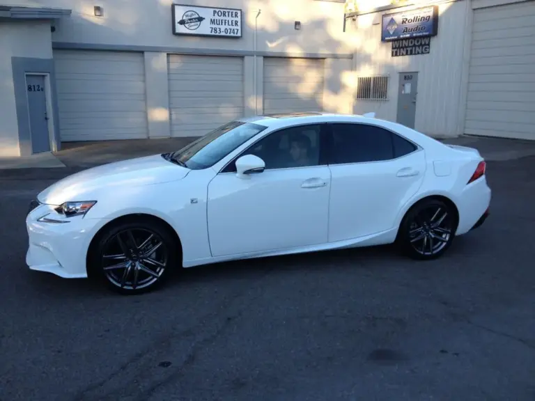 White Lexus IS sedan with tinted windows outside the shop