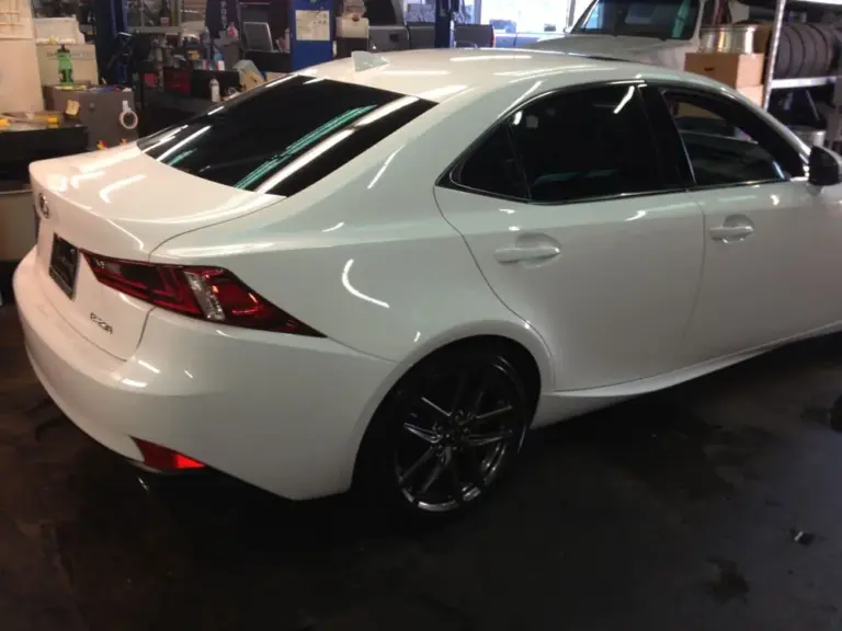 White Lexus IS from behind, with tinted windows