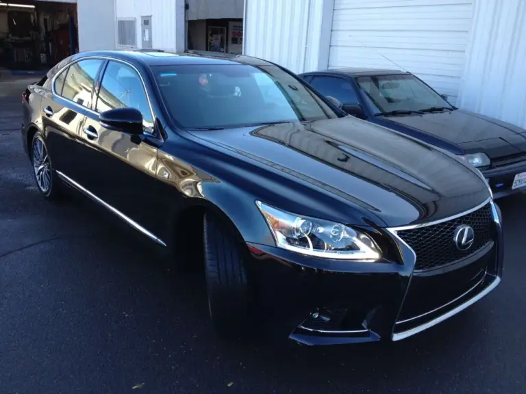Black Lexus LS with tinted windows outside the shop