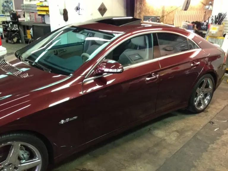 Burgundy Mercedes CLS with tinted windows and sunroof