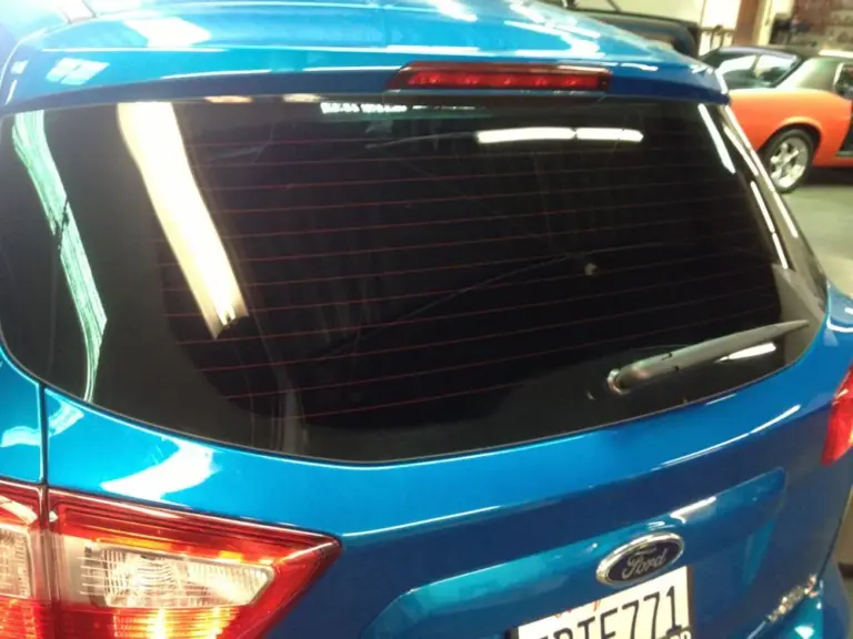 Blue Ford hatchback with a freshly tinted rear window