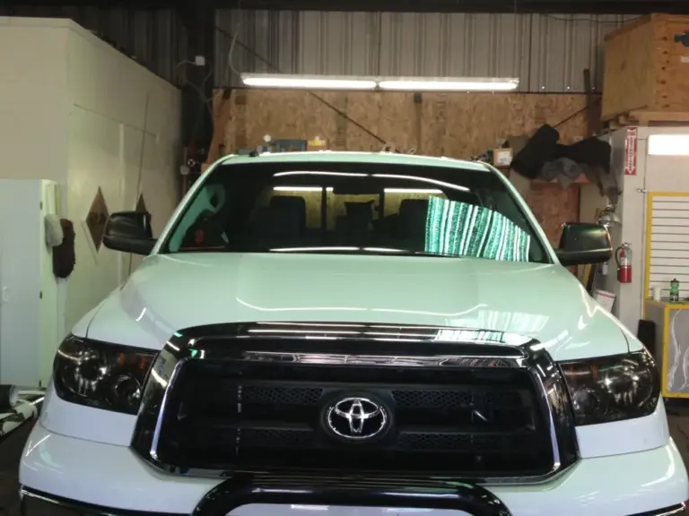 White Toyota Tundra with tinted windows and smoked headlights